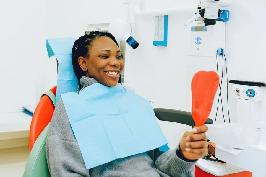 Patient admiring her new smile at the Fort Myers dentist